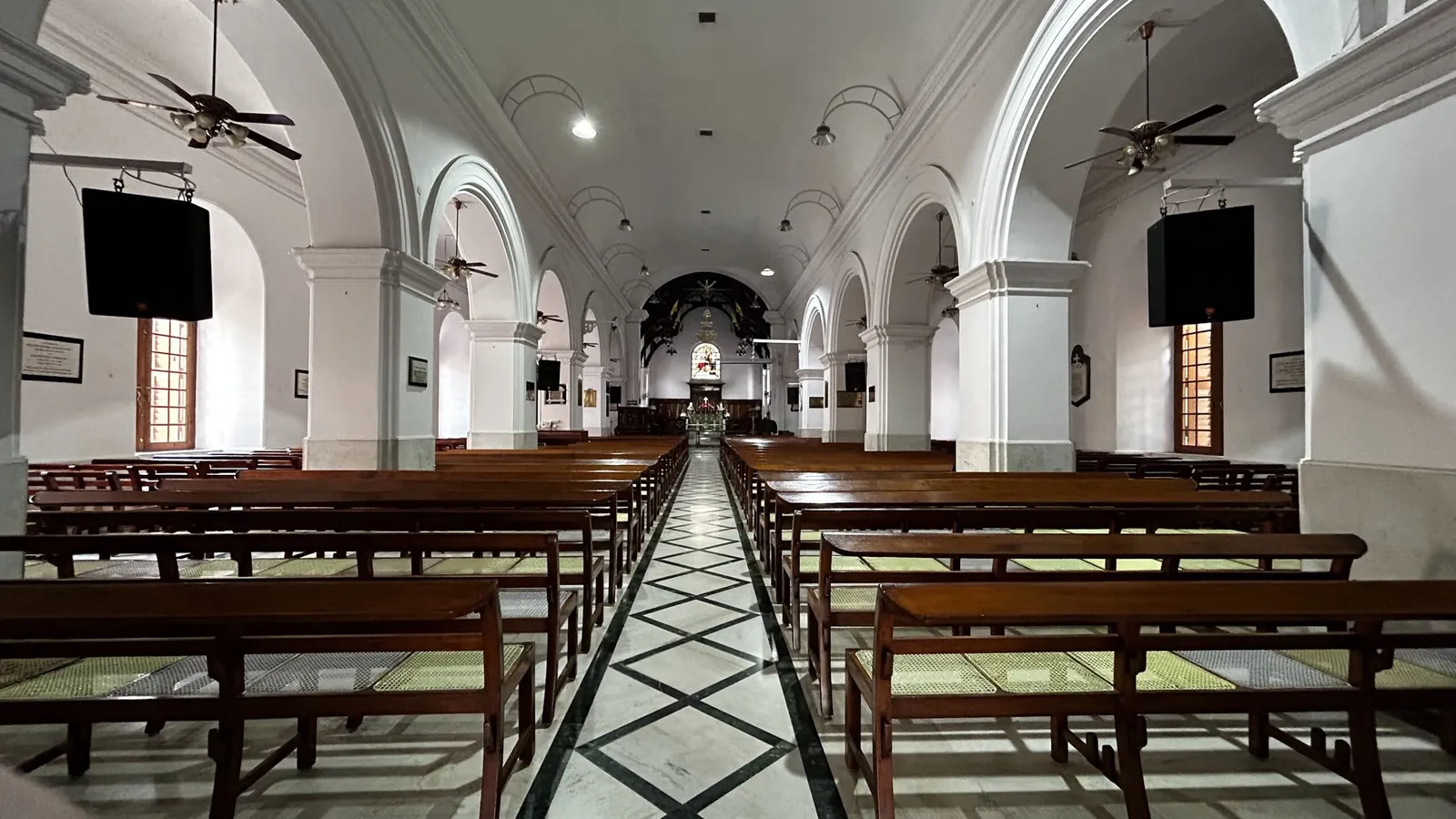 The nave and wooden pews inside Holy Trinity Church